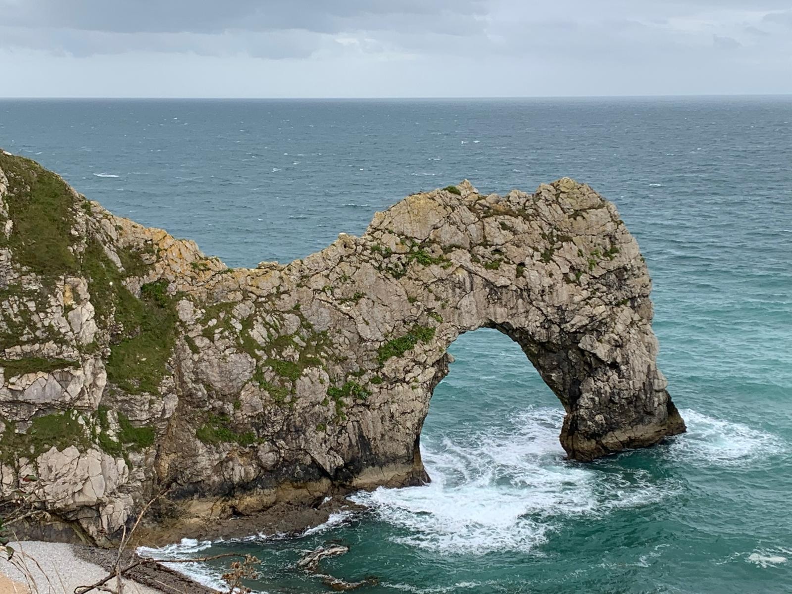 Rocky coastal sea arch above ocean waves